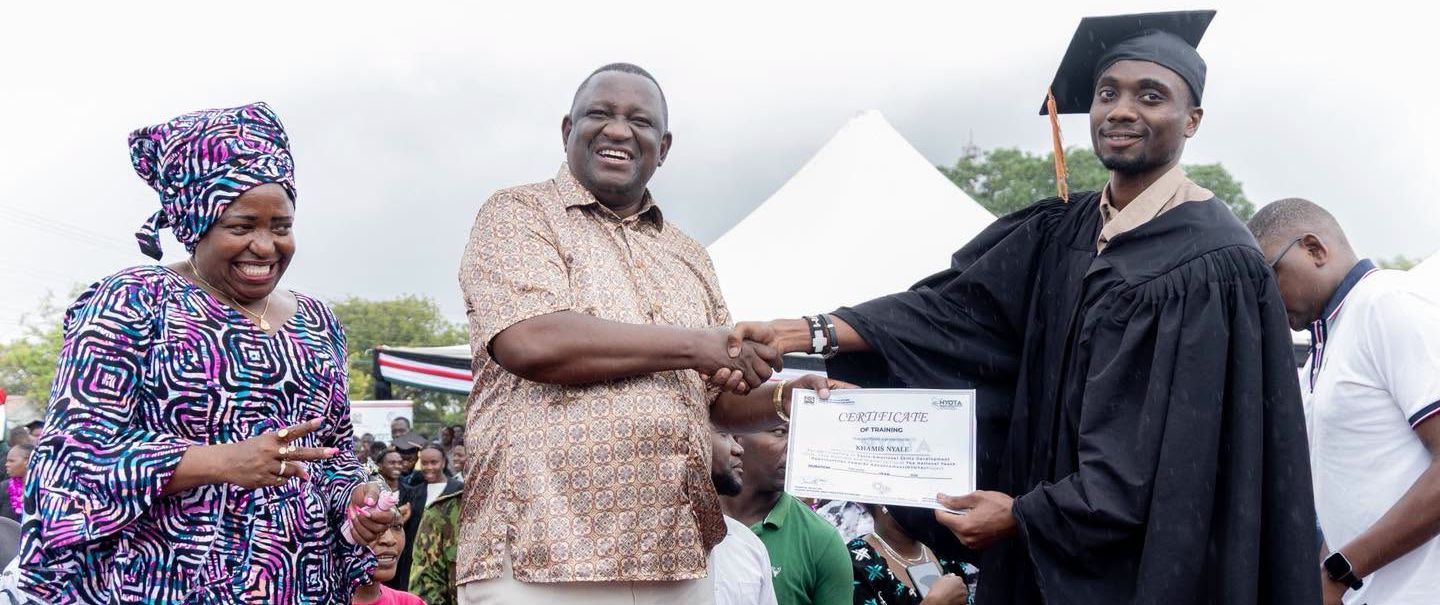 A young NYOTA beneficiary receives a certificate.